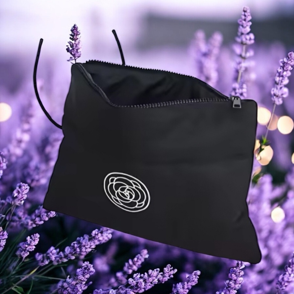 NWOT. Black Minimalist Cosmetic Bag with Circular Emblem Flower design.